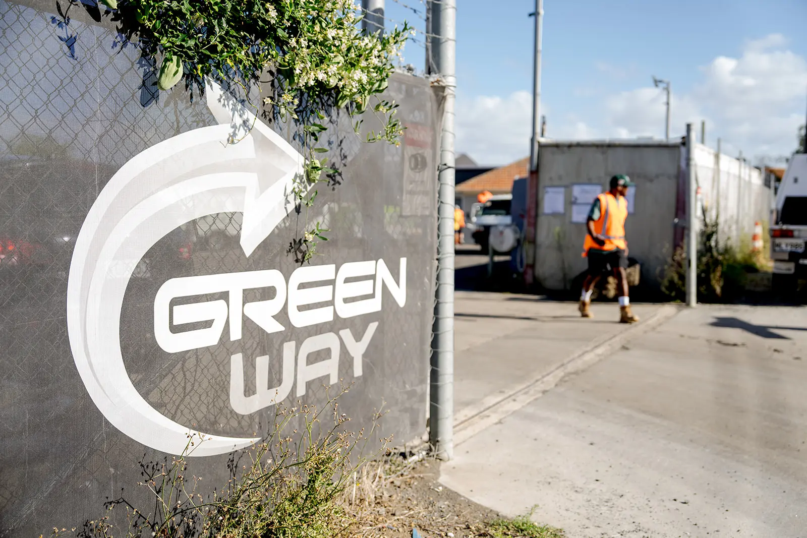 Green Way sign with construction worker wearing hi-viz in background